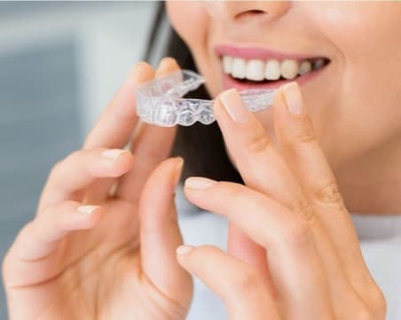 A clear aligner held ready to wear A clear aligner held ready to wear